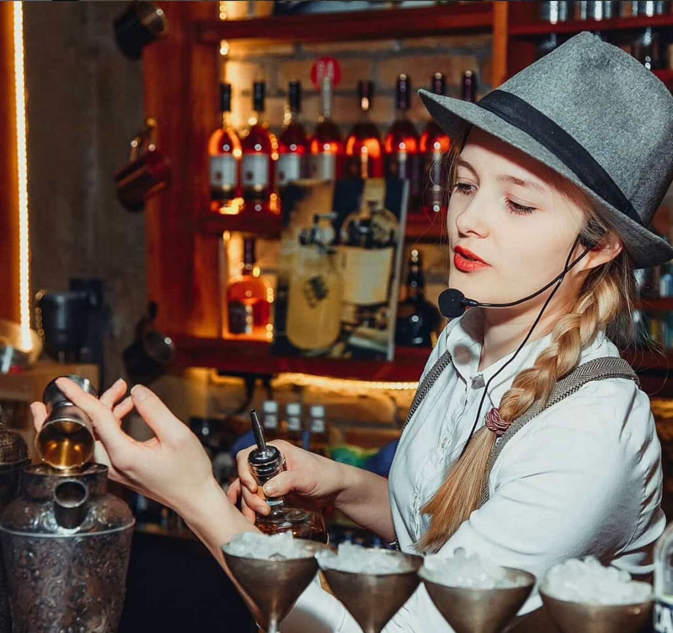 Irina, BeeHive’s founder, preparing cocktails behind a bar