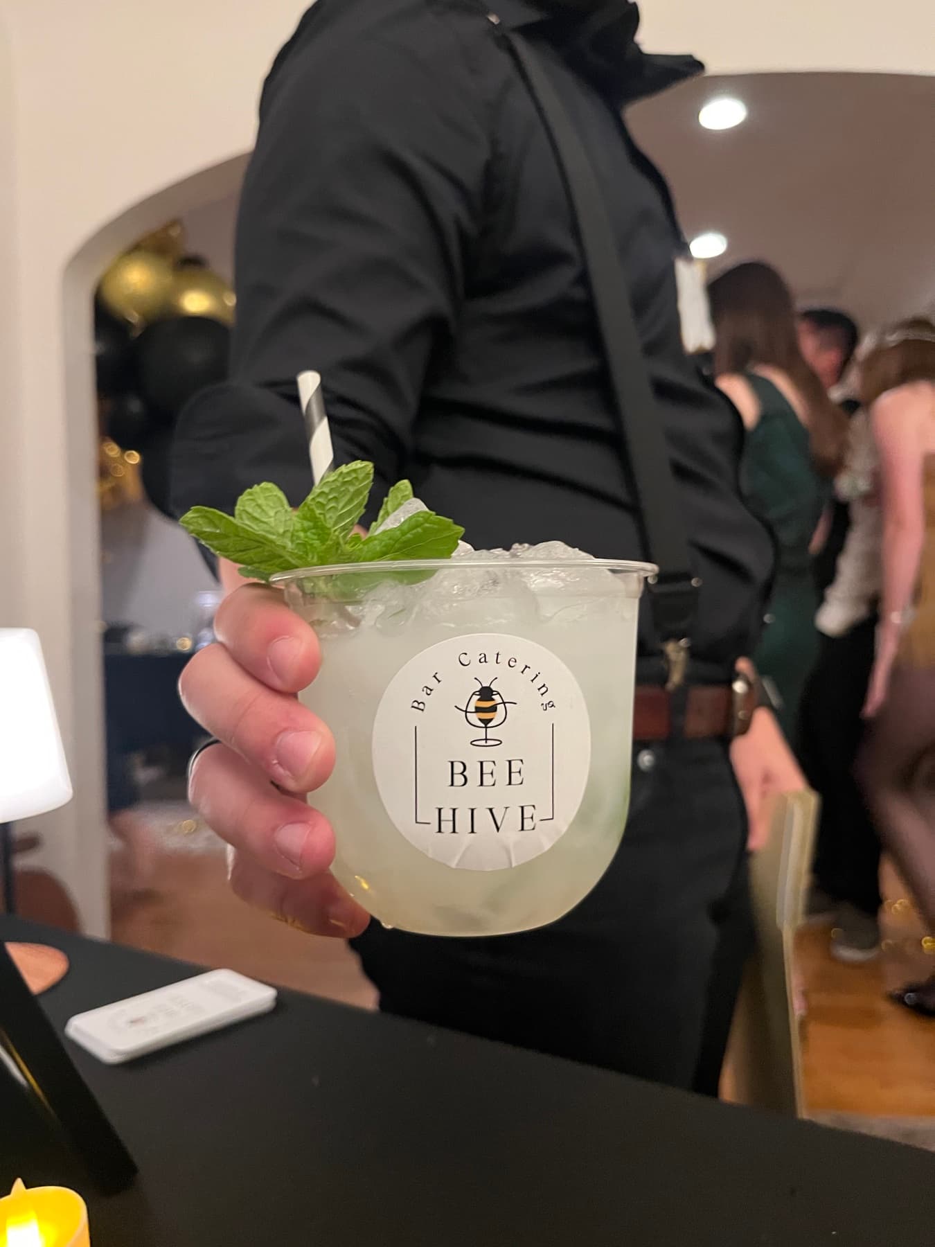 BeeHive bartender serving a branded cocktail at an event