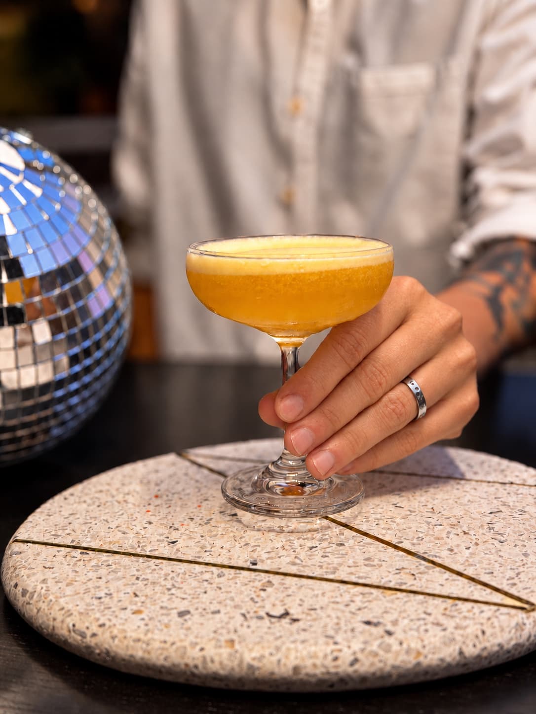BeeHive bartender serving a signature cocktail
